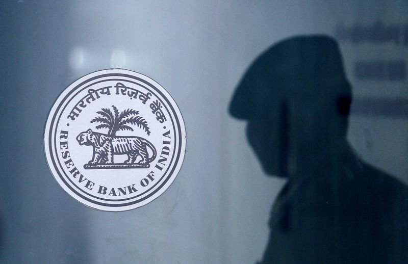 &copy; Reuters. FILE PHOTO: A security guard's reflection is seen next to the logo of the Reserve Bank Of India (RBI) at the RBI headquarters in Mumbai, India, June 6, 2019. REUTERS/Francis Mascarenhas