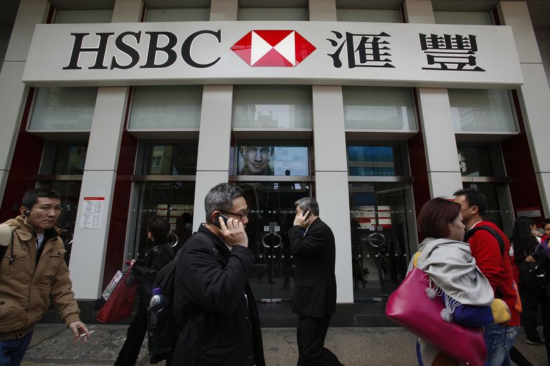 &copy; Reuters. FILE PHOTO: People walk outside one of the branches of HSBC in Hong Kong March 4, 2013. REUTERS/Bobby Yip (CHINA - Tags: BUSINESS)