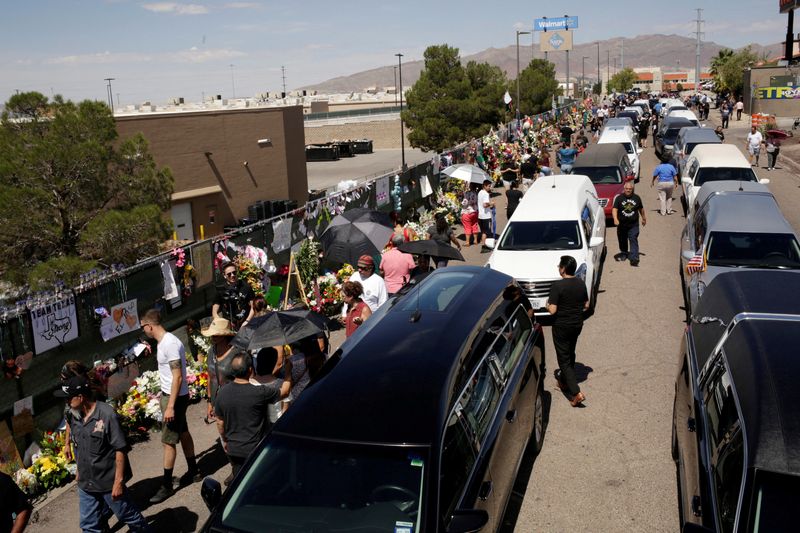 &copy; Reuters. FILE PHOTO: People gather during a tribute to the victims of a mass shooting at a Walmart store, in the growing memorial in El Paso, Texas, U.S., August 18, 2019. REUTERS/Jose Luis Gonzalez