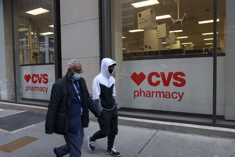 &copy; Reuters. FILE PHOTO: People walk by a CVS pharmacy store in Manhattan, New York, U.S., November 15, 2021. REUTERS/Andrew Kelly