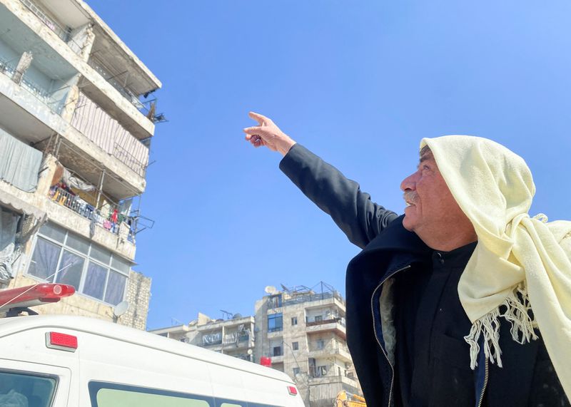 &copy; Reuters. Masoud Douba, an Aleppo resident who was evacuated from a building for safety, points at buildings impacted by the earthquake in Aleppo, Syria February 9, 2023. REUTERS/Firas Makdesi