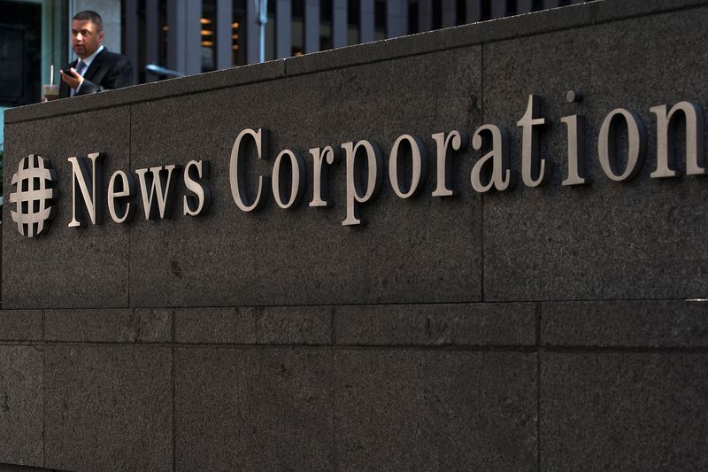 &copy; Reuters. FILE PHOTO: A passer-by stands in front of the News Corporation building in New York June 28, 2012.  REUTERS/Keith Bedford/File Photo               