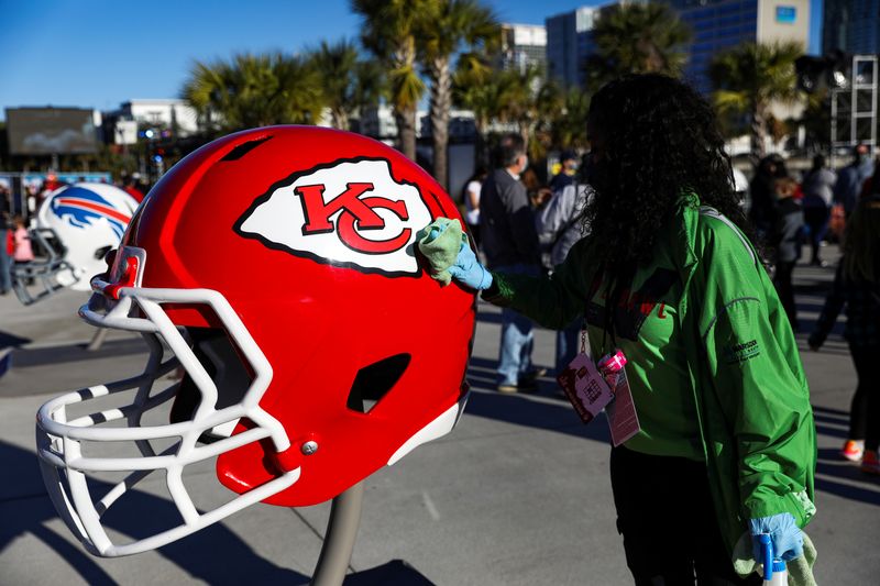 &copy; Reuters. FILE PHOTO: An employee cleans a large Kansas City Chiefs football helmet that people pose for photos with at The Super Bowl Experience Presented By Lowe's event ahead of the weekend's Super Bowl LV between the Kansas City Chiefs and Tampa Bay Buccaneers 
