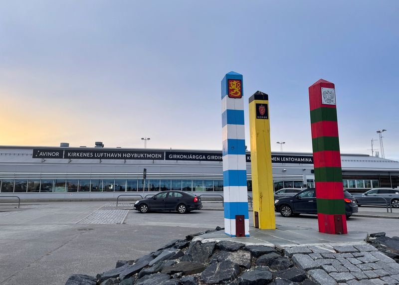 &copy; Reuters. FILE PHOTO: The border posts of Finland (blue and white), Norway (black and yellow) and Russia (red and green), stand outside the airport of the Norwegian Arctic town of Kirkenes, Norway, May 8, 2022. Picture taken May 8, 2022. REUTERS/Gwladys Fouche/File