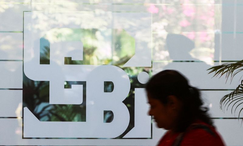 &copy; Reuters. A woman walks past the logo of the Securities and Exchange Board of India (SEBI), at its headquarters in Mumbai, India, May 27, 2022. REUTERS/Francis Mascarenhas