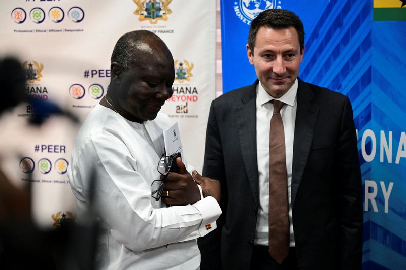 &copy; Reuters. FILE PHOTO: Ghana's Finance Minister Ken Ofori-Atta stands next to Stephane Roudet, IMF Mission Chief for Ghana, during a news conference in Accra, Ghana December 13, 2022. REUTERS/Cooper Inveen/File Photo