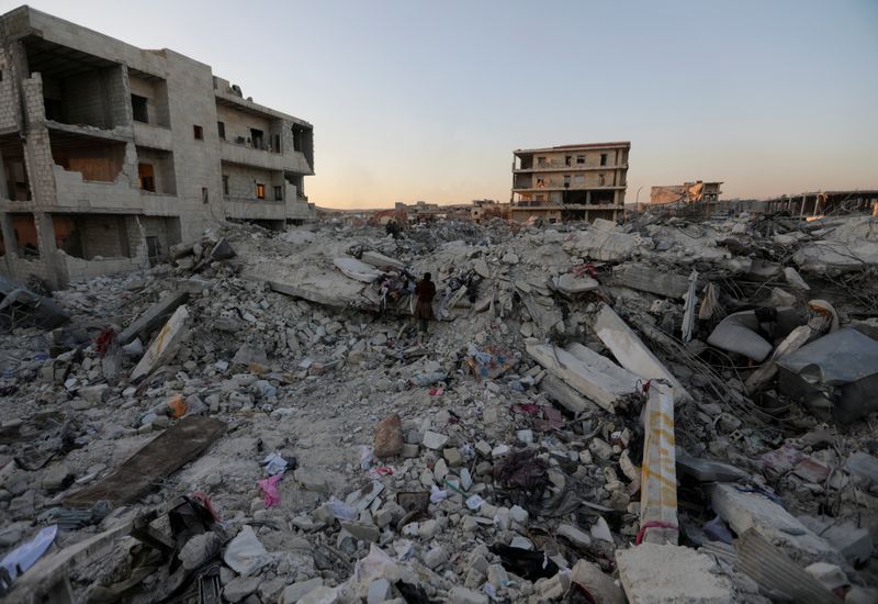 &copy; Reuters. FILE PHOTO: People stand on the rubble of damaged buildings, in the aftermath of an earthquake, in rebel-held town of Jandaris, Syria February 9, 2023.  REUTERS/Khalil Ashawi