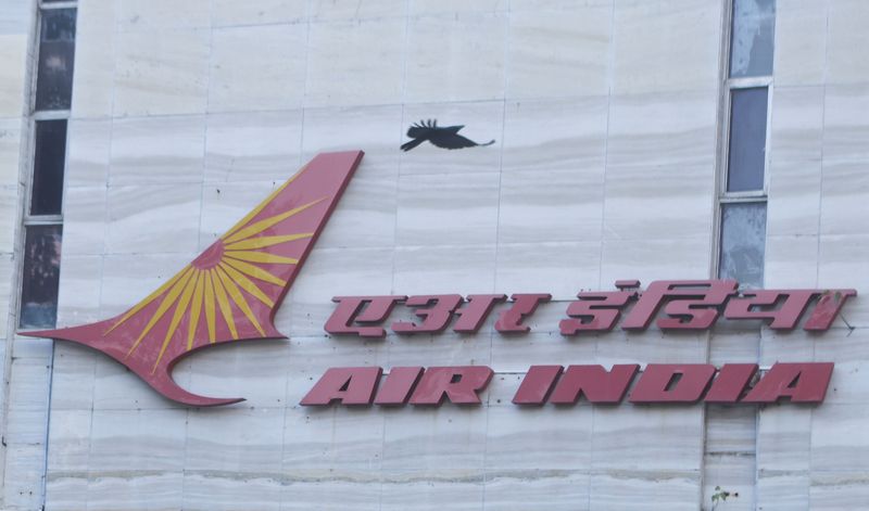 &copy; Reuters. FILE PHOTO: A bird flies over a logo of Air India airlines at the corporate headquarters in Mumbai, India, October 19, 2021. REUTERS/Francis Mascarenhas