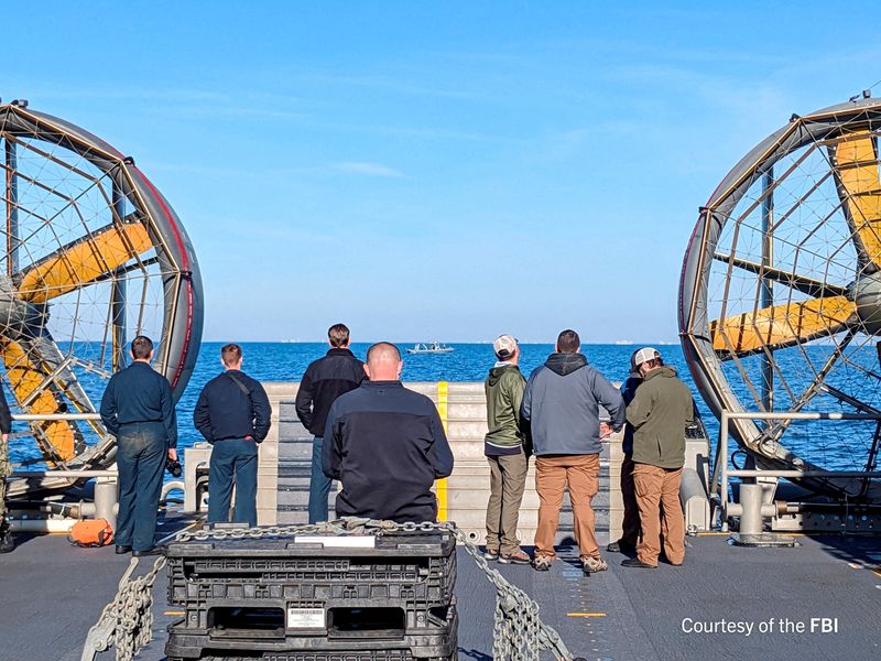 &copy; Reuters. FILE PHOTO: An undated U.S. Federal Bureau of Investigation handout photo taken aboard the USS Carter Hall off South Carolina shows FBI Special Agents assigned to the bureau’s Evidence Response Team ready to process material recovered from the high-alti