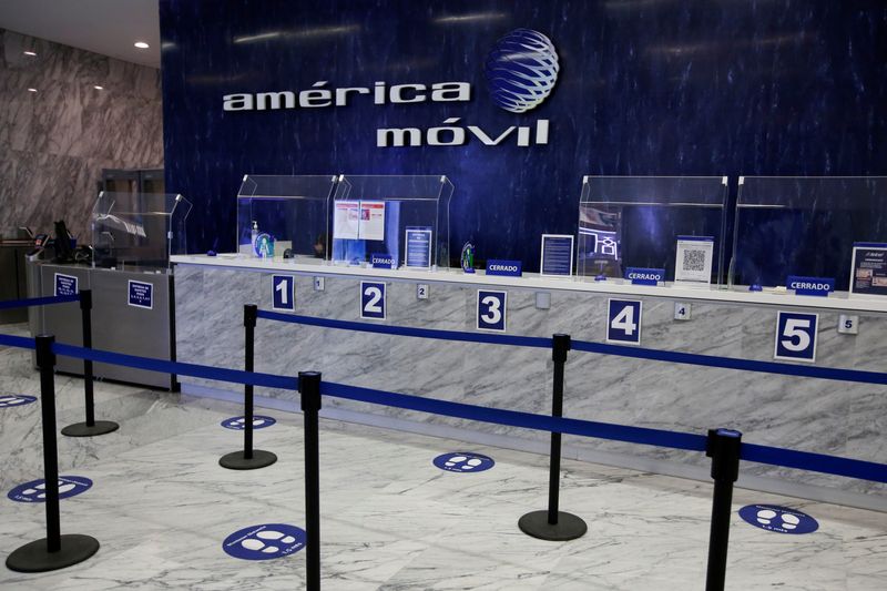 &copy; Reuters. The logo of America Movil is pictured on the wall at a reception area in the company's corporate offices, in Mexico City, Mexico January 25, 2022. REUTERS/Gustavo Graf