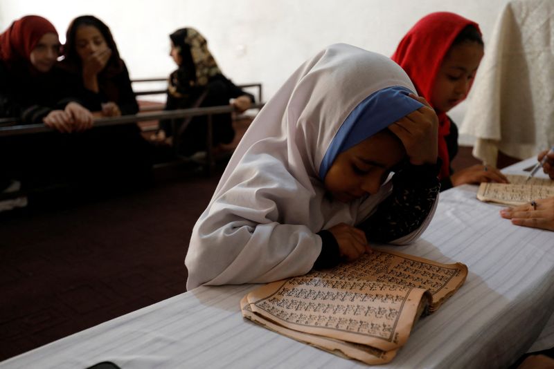 &copy; Reuters. An Afghan girl reads the Koran in a madrasa or religious school in Kabul, Afghanistan, October 8, 2022. REUTERS/Ali Khara