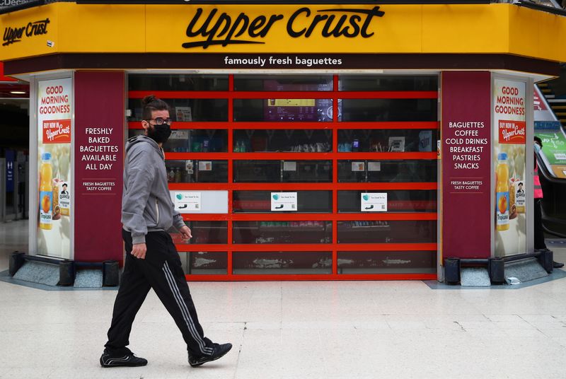 &copy; Reuters. A man wearing a protective mask walks past an Upper Crust at Victoria Station in London, Britain July 1, 2020. REUTERS/Hannah Mckay/File Photo