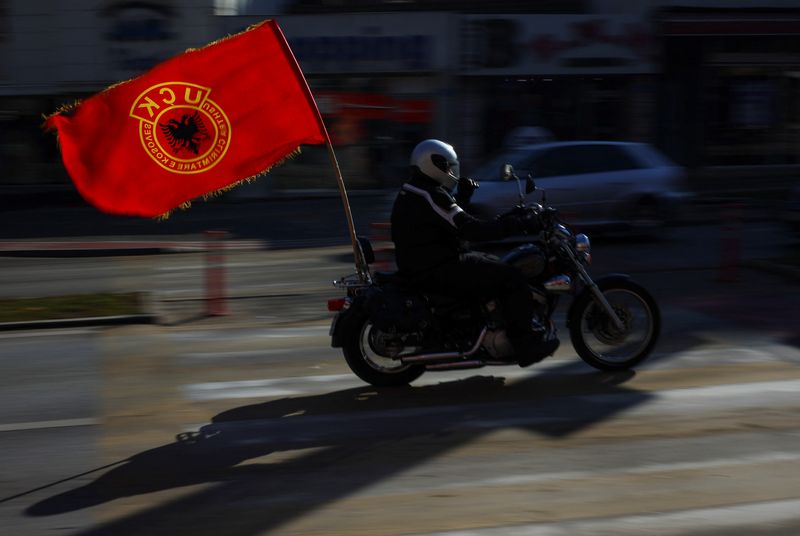 &copy; Reuters. A person rides on a motorcycle with Kosovo Liberation Army (KLA) flag attached to it on the day of celebrations of the 15th anniversary of Kosovo independence in Pristina, Kosovo, February 17, 2023. REUTERS/Florion Goga