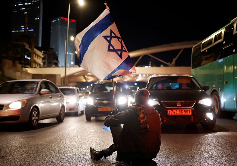 &copy; Reuters. FILE PHOTO: A demonstrator blocks a road during a protest against Israel's Prime Minister Benjamin Netanyahu's new right-wing coalition and its proposed judicial changes to reduce powers of the Supreme Court in Tel Aviv, Israel February 18, 2023. REUTERS/