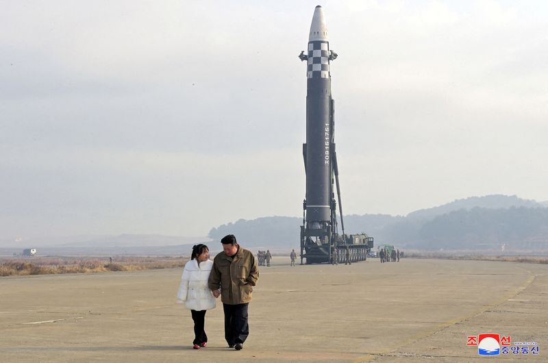 © Reuters. FILE PHOTO: North Korean leader Kim Jong Un, along with his daughter, walks away from an intercontinental ballistic missile (ICBM) in this undated photo released on November 19, 2022 by North Korea's Korean Central News Agency (KCNA). KCNA via REUTERS/File Photo