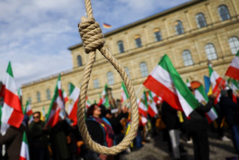 &copy; Reuters. A noose is seen as people hold Iranian flags during a protest on the day of the Munich Security Conference, in Munich, Germany February 17, 2023. REUTERS/Kai Pfaffenbach
