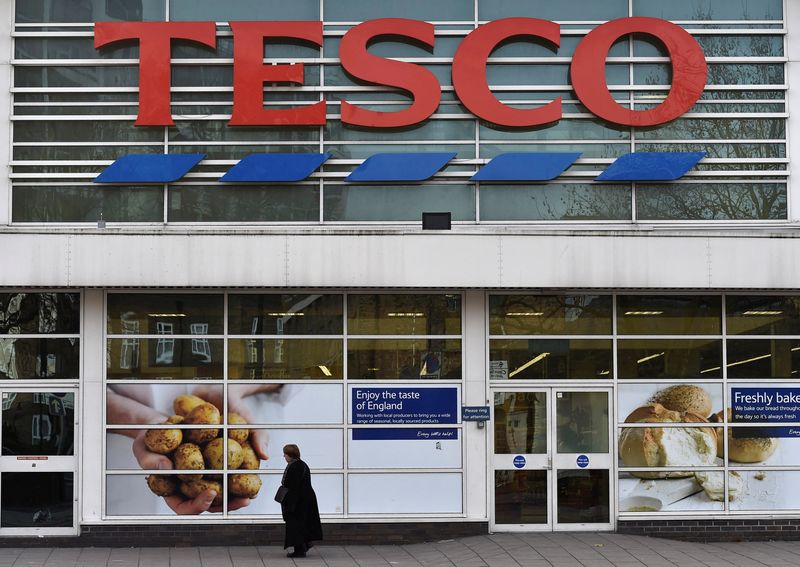 &copy; Reuters. FILE PHOTO: A woman walks past a Tesco supermarket in central London, December 9, 2014. REUTERS/Toby Melville/File Photo