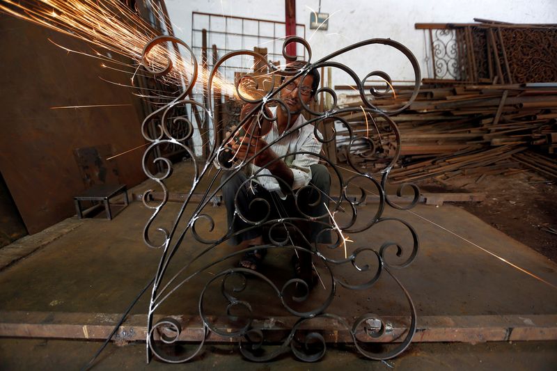 &copy; Reuters. FILE PHOTO: A worker grinds a metal window grill at a steel and iron manufacturing unit in Ahmedabad, India, October 3, 2016. REUTERS/Amit Dave