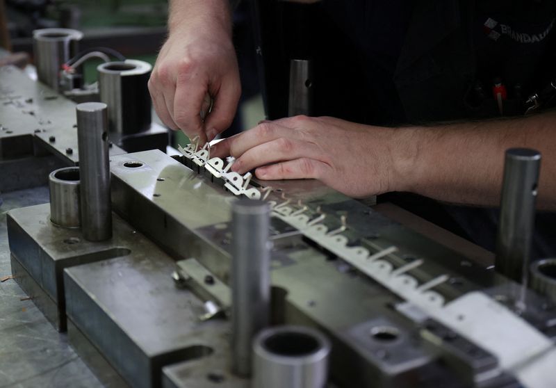 &copy; Reuters. FILE PHOTO: A worker in Brandauer's factory processes new orders as they benefit from the reshoring of manufacturing following global supply chain disruption in Birmingham, Britain, July 28, 2022. REUTERS/Molly Darlington