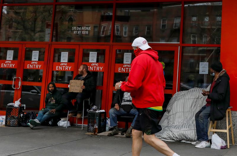 &copy; Reuters. Homeless people gather outside a closed AMC Theatre during the outbreak of the coronavirus disease (COVID-19), in New York City, U.S., April 29, 2020. REUTERS/Brendan McDermid