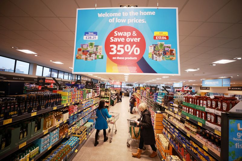&copy; Reuters. Shoppers push trolleys along an aisle inside an ALDI supermarket near Altrincham, Britain, February 20, 2023. REUTERS/Phil Noble