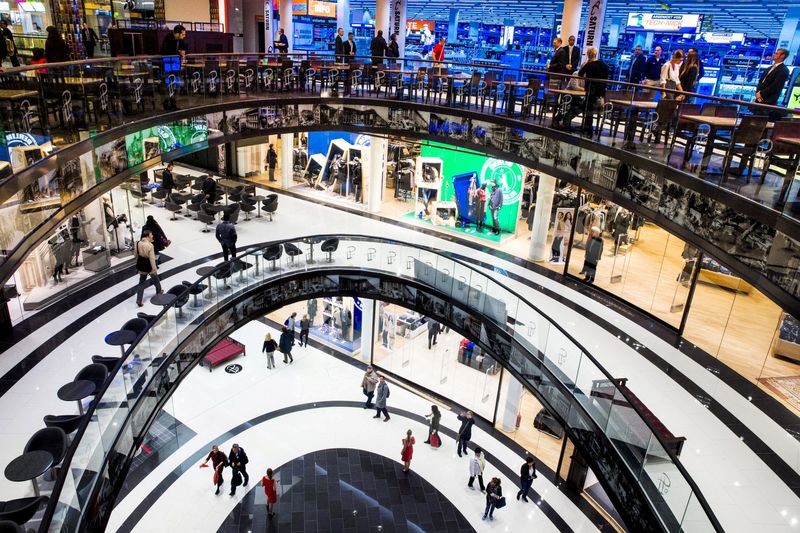 &copy; Reuters. FILE PHOTO: People walk through the Mall of Berlin shopping centre during its opening night in Berlin, Germany, September 24, 2014. REUTERS/Thomas Peter