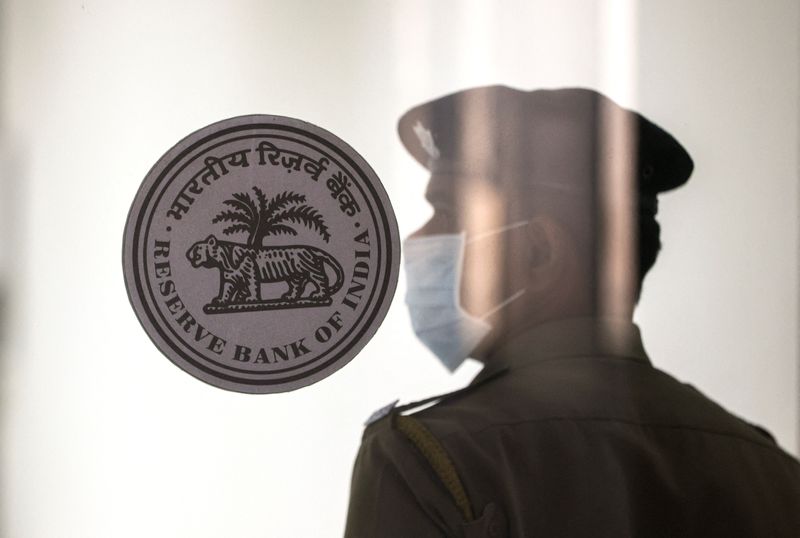 &copy; Reuters. FILE PHOTO: A security guard stands next to the logo of the Reserve Bank of India (RBI) inside its headquarters in Mumbai, India, February 8, 2023. REUTERS/Francis Mascarenhas