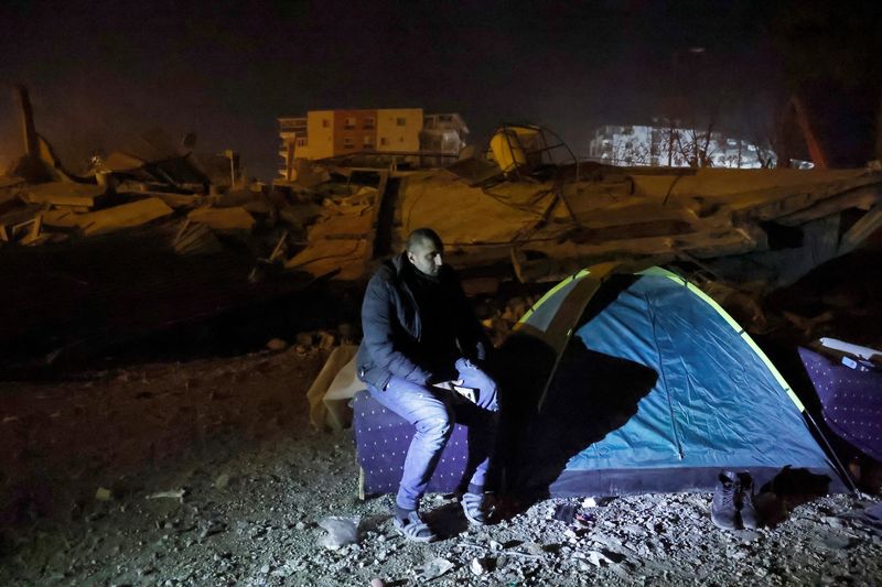 &copy; Reuters. مصطفى قزاز من أصل سوري يجلس بجانب خيمة يعيش فيها الآن في موقع المبنى السكني المنهار في أعقاب زلزال مدمر في أنطاكية بإقليم هاتاي في تركيا يوم 