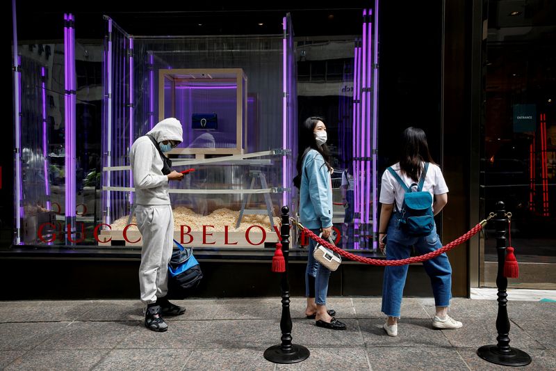 &copy; Reuters. FILE PHOTO: Shoppers wait in line to enter the Gucci store on 5th Avenue in New York City, U.S., May 24, 2021.  REUTERS/Brendan McDermid