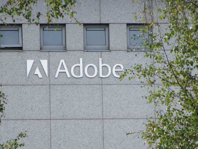 &copy; Reuters. FILE PHOTO: A logo of Adobe Inc. is pictured at the company's office in Citywest Business Campus, Saggart, Ireland October 19, 2021. Picture taken October 19, 2021. REUTERS/ Tom Bergin
