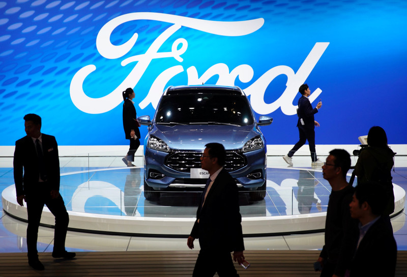 &copy; Reuters. FILE PHOTO: People walk by a Ford Escape SUV displayed during the media day for the Shanghai auto show in Shanghai, China April 16, 2019. REUTERS/Aly Song