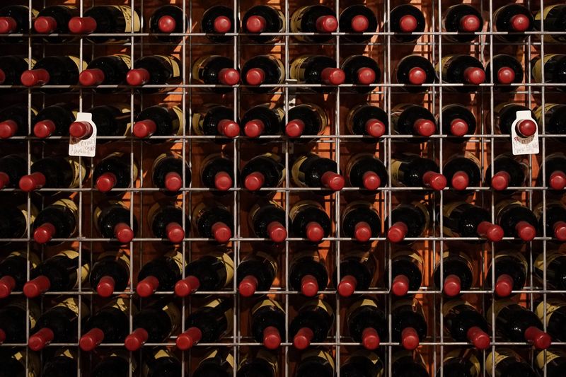 &copy; Reuters. FILE PHOTO: Bottles of wine sit on racks inside the cellar door tasting room at Petersons Wines, November 14, 2021.  REUTERS/Loren Elliott