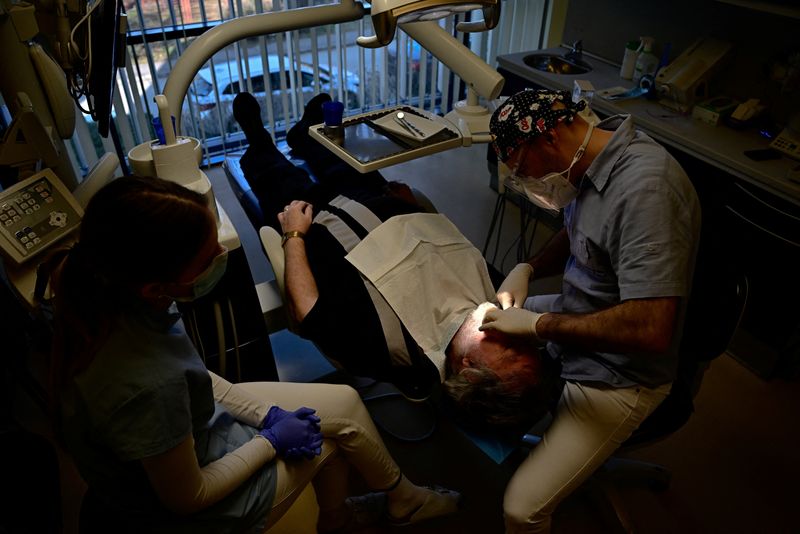 &copy; Reuters. FILE PHOTO: Hungarian dentist Ivan Solymosi checks British patient Bob Martin's implants at the Kreativ Dental Clinic in Budapest, Hungary, February 10, 2023. REUTERS/Marton Monus