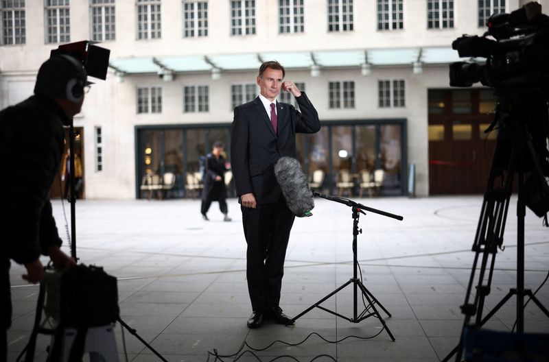 &copy; Reuters. FILE PHOTO: British Chancellor of the Exchequer Jeremy Hunt talks to a television crew outside the BBC headquarters in London, Britain November 18, 2022. REUTERS/Henry Nicholls