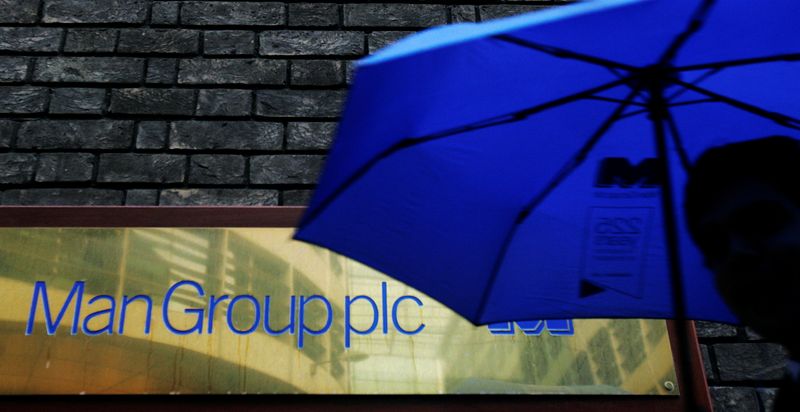 &copy; Reuters. FILE PHOTO: A man passes a sign for fund manager Man Group in London, November 6, 2008.  REUTERS/Luke MacGregor/File Photo