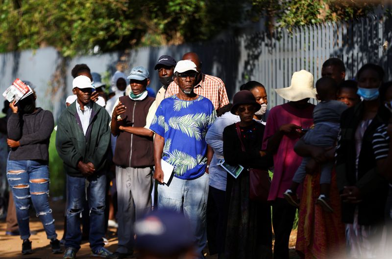 &copy; Reuters. Social grant recipients stand in a queue outside a post office, as joblessness takes its toll in Meadowlands, a suburb of Soweto, South Africa, February 24, 2022.   REUTERS/Siphiwe Sibeko