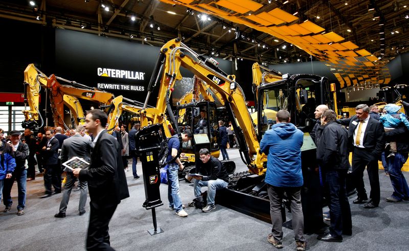 &copy; Reuters. FILE PHOTO: People visit the Caterpillar stand at the 'Bauma' Trade Fair for Construction Machinery, Building Material Machines, Mining Machines, Construction Vehicles and Construction Equipment in Munich, Germany, April 8, 2019. REUTERS/Michaela Rehle