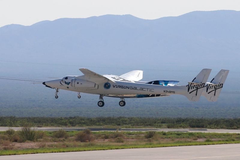 © Reuters. FILE PHOTO: Virgin Galactic's passenger rocket plane VSS Unity, borne by twin-fuselage carrier jet dubbed VMS Eve, takes off with billionaire entrepreneur Richard Branson and his crew for travel to the edge of space at Spaceport America near Truth or Consequences, New Mexico, U.S., July 11, 2021. REUTERS/Joe Skipper