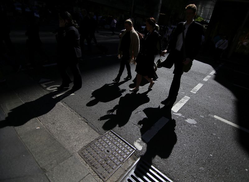 &copy; Reuters. FILE PHOTO: Office workers cross a street in Sydney, Australia, September 4, 2017. Picture taken September 4, 2017.    REUTERS/Steven Saphore