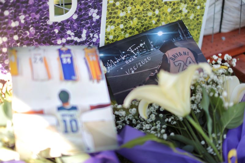 &copy; Reuters. FILE PHOTO: Flowers and pictures are seen as fans gather for a memorial to late Kobe Bryant, who perished one year ago alongside his daughter and seven others when their helicopter crashed into a hillside near Los Angeles, outside the Staples Center in Lo