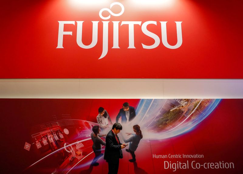 &copy; Reuters. FILE PHOTO: A man looks at his mobile in front of a Fujitsu advert during the Mobile World Congress in Barcelona, Spain, February 27, 2018. REUTERS/Yves Herman    