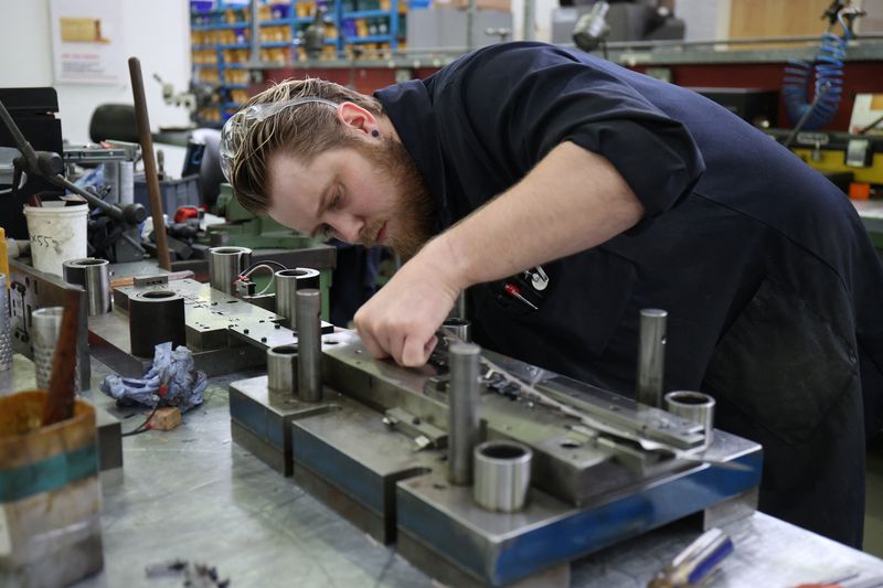 &copy; Reuters. FILE PHOTO; A worker in Brandauer's factory processes new orders as they benefit from the reshoring of manufacturing following global supply chain disruption in Birmingham, Britain, July 28, 2022. REUTERS/Molly Darlington