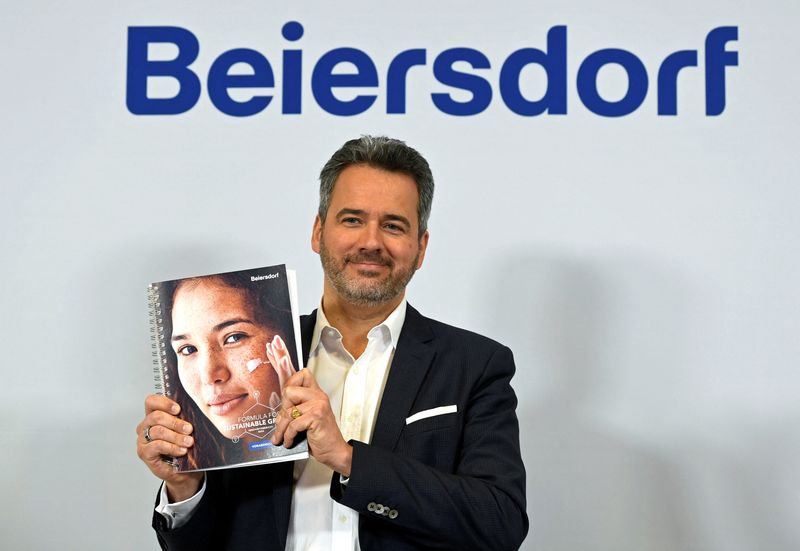 © Reuters. Vincent Warnery, CEO of German personal care company Beiersdorf, holds the annual report as he poses for media prior the annual news conference at the company's headquarters in Hamburg, Germany, March 1, 2023. REUTERS/Fabian Bimmer