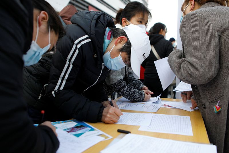 &copy; Reuters. FILE PHOTO: Job seekers visit a booth at a job fair in Beijing, China February 16, 2023. REUTERS/Florence Lo