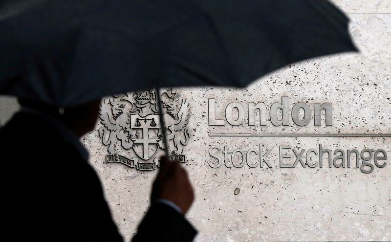&copy; Reuters. Un uomo con ombrello di fronte alla sede della Borsa di Londra. 24 agosto 2015 REUTERS/Suzanne Plunkett/File Photo/File Photo