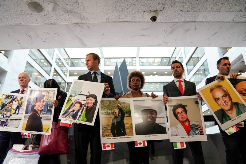 &copy; Reuters. FILE PHOTO: Family members hold photographs of Boeing 737 MAX crash victims lost in two deadly 737 MAX crashes that killed 346 people as they arrive for Boeing CEO Dennis Muilenburg's testimony before a Senate Commerce, Science and Transportation Committe