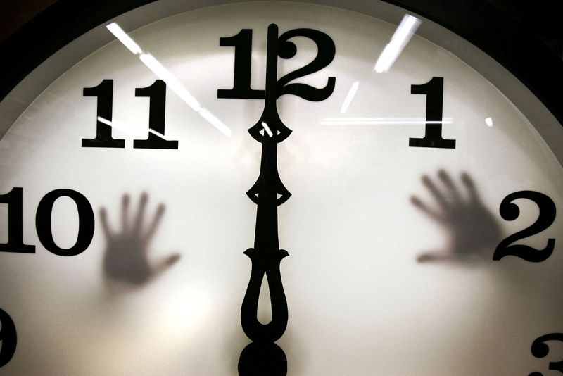 &copy; Reuters. FILE PHOTO: Technicians work on a five-foot tower clock at the Electric Time Company in Medfield, Massachusetts March 31, 2006