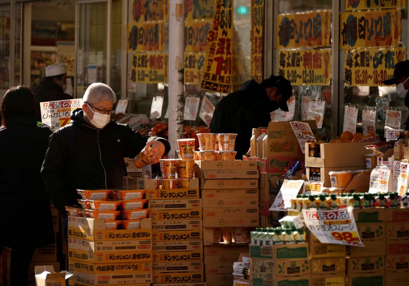 &copy; Reuters. FILE PHOTO: Shoppers check foods at a supermarket in Tokyo, Japan January 10, 2023. REUTERS/Issei Kato