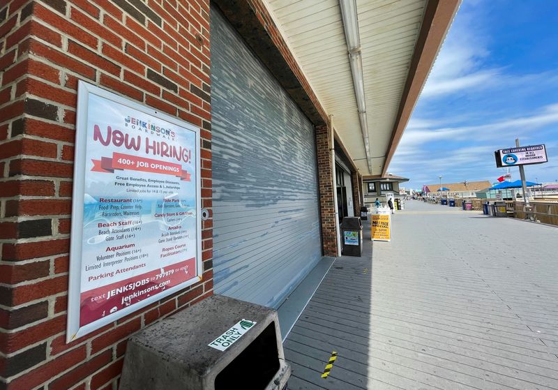 &copy; Reuters. FILE PHOTO: A sign advertising job openings at Jenkinson’s Boardwalk is posted in Point Pleasant Beach, New Jersey, U.S., May 25, 2021. REUTERS/Joseph Ax/File Photo