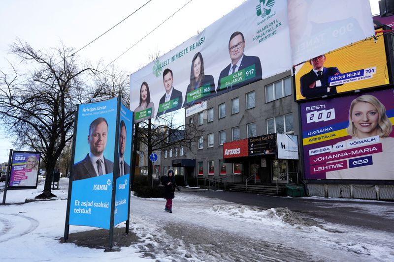 &copy; Reuters. FILE PHOTO: A person walks past Estonian political parties general election campaign placards next to the shopping mall in Tallinn, Estonia March 1, 2023. REUTERS/Ints Kalnins